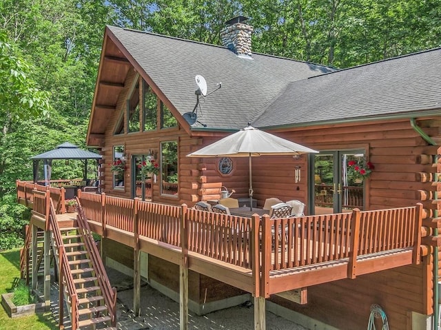 wooden deck featuring a gazebo, french doors, and stairs