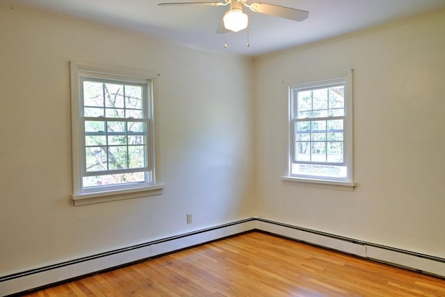 spare room with crown molding, a ceiling fan, light wood-style flooring, and baseboard heating