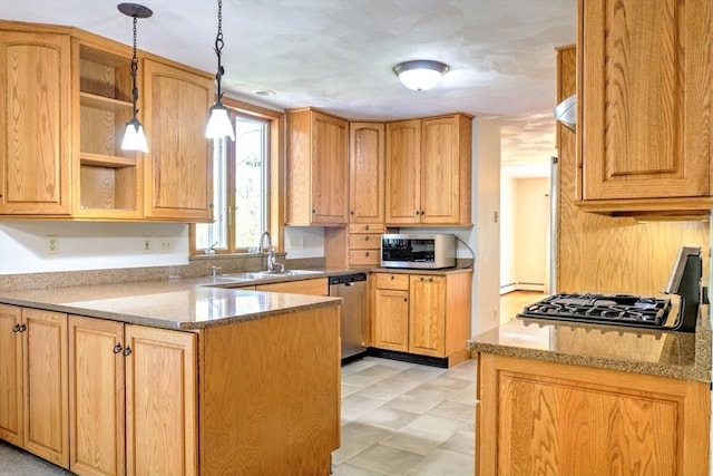 kitchen with light stone counters, a sink, a peninsula, and stainless steel appliances