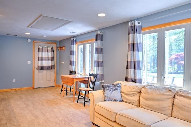 living room with baseboards, recessed lighting, light wood-style flooring, and visible vents