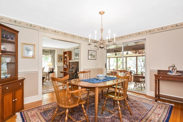 21 Stevens Rd, Needham, MA 02492 - dining area featuring a chandelier, light wood-style floors, radiator, and baseboards