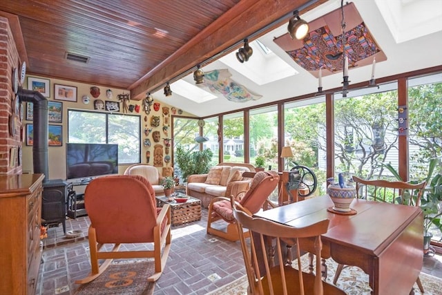 21 Stevens Rd, Needham, MA 02492 - sunroom with a skylight, a wood stove, brick patterned flooring, plenty of natural light, and wooden ceiling