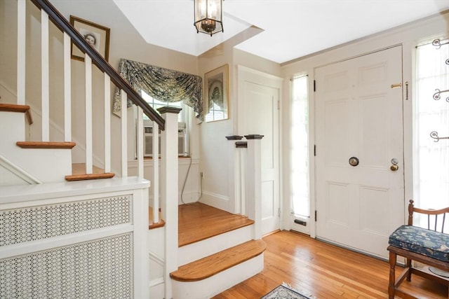 21 Stevens Rd, Needham, MA 02492 - entrance foyer featuring stairway, light wood finished floors, and cooling unit