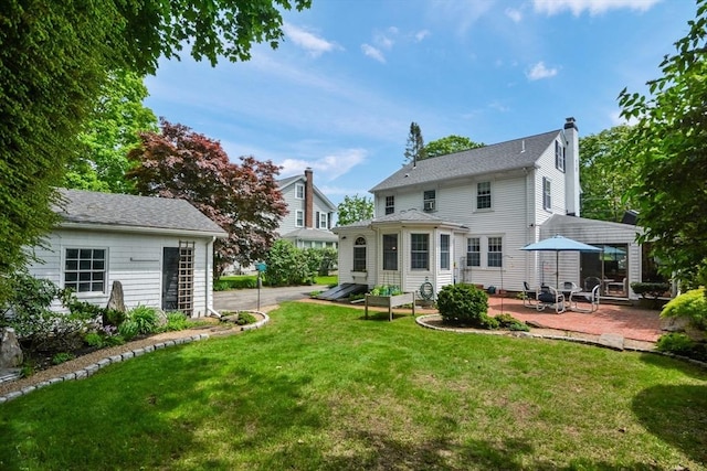 21 Stevens Rd, Needham, MA 02492 - back of property with a patio, a chimney, and a yard