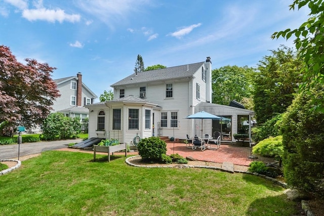 21 Stevens Rd, Needham, MA 02492 - rear view of house featuring a patio, a yard, a chimney, and entry steps