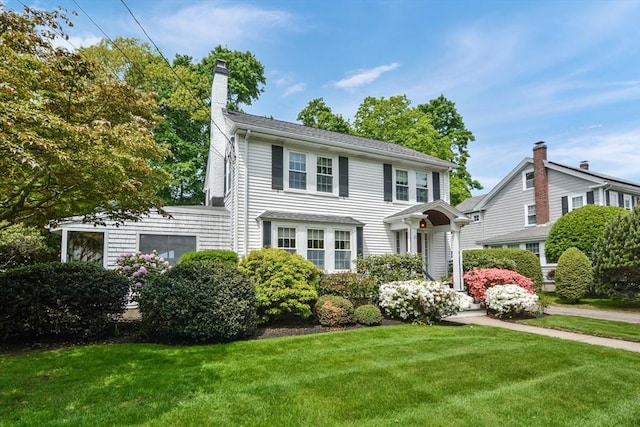 21 Stevens Rd, Needham, MA 02492 - view of front facade with a front lawn and a chimney