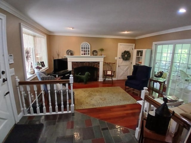 100 D Dr, Westport, MA 02790 - living area featuring a brick fireplace, healthy amount of natural light, ornamental molding, wood finished floors, and recessed lighting