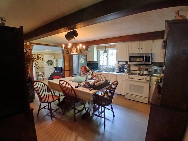 100 D Dr, Westport, MA 02790 - dining space featuring beam ceiling, wood finished floors, and a chandelier
