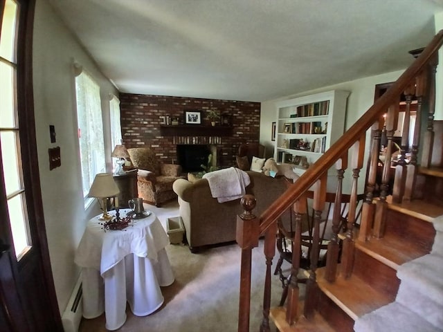100 D Dr, Westport, MA 02790 - living room with stairs, a fireplace, a baseboard heating unit, and built in shelves