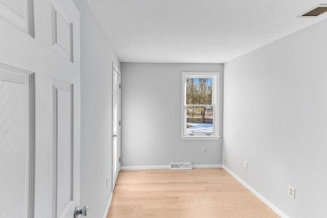 spare room with light hardwood / wood-style floors