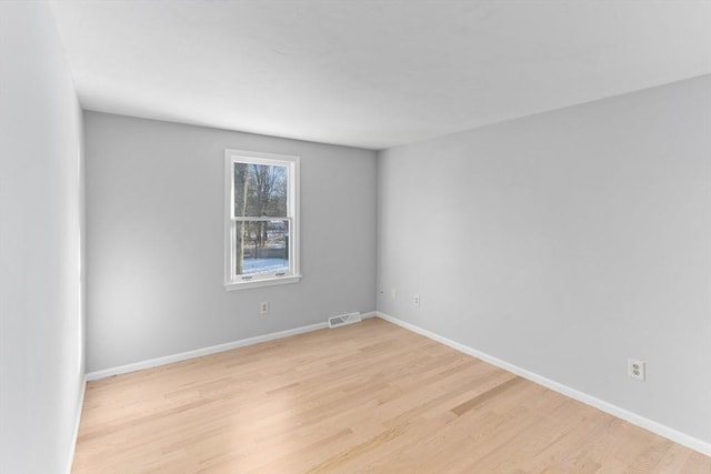 spare room featuring light hardwood / wood-style flooring