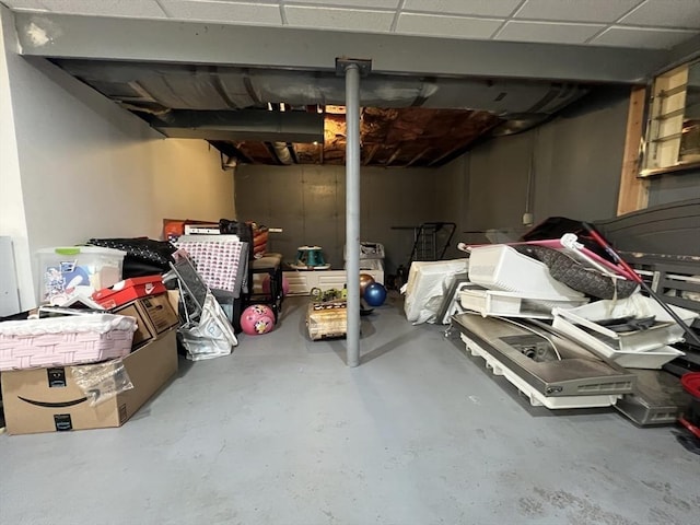 basement with a paneled ceiling