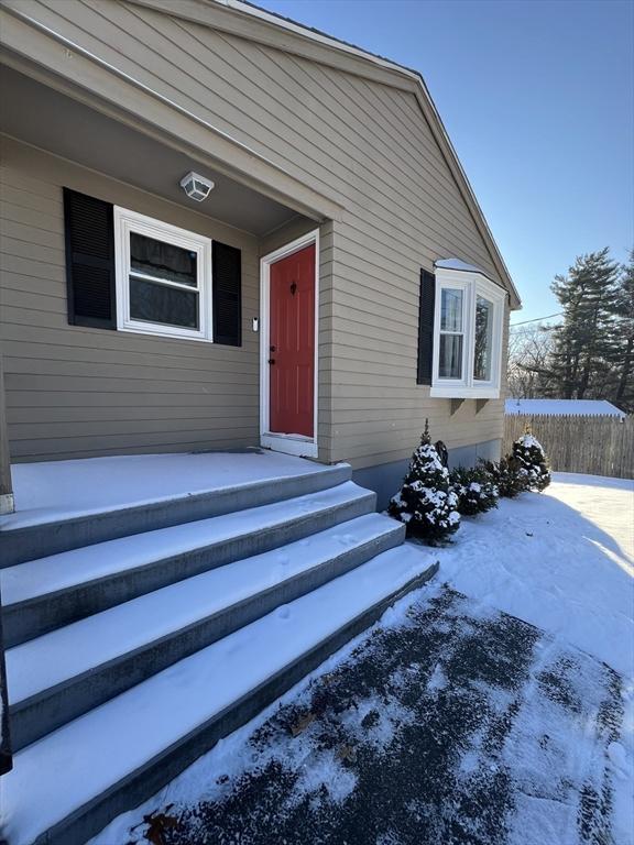 view of snow covered property entrance