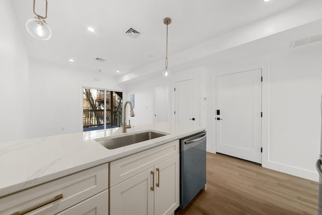 kitchen with white cabinets, stainless steel dishwasher, hanging light fixtures, and sink