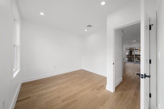 spare room with light hardwood / wood-style flooring