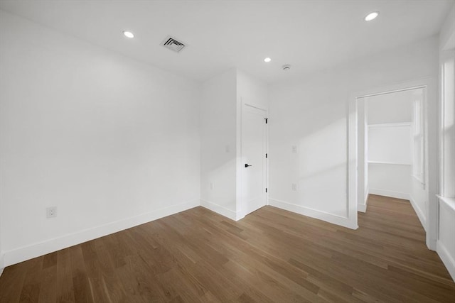 spare room featuring dark hardwood / wood-style flooring