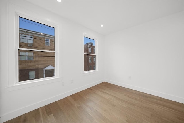 spare room with light wood-type flooring