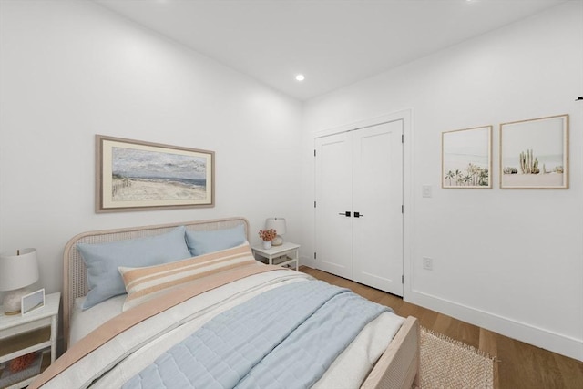 bedroom featuring hardwood / wood-style floors and a closet