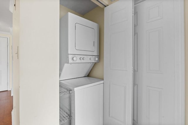 clothes washing area with laundry area and stacked washer / drying machine