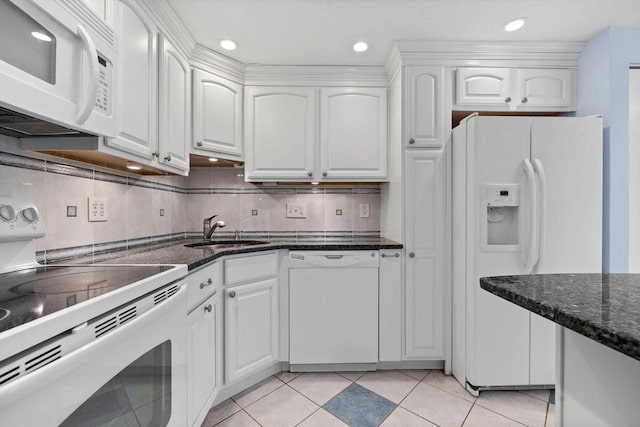 kitchen with white cabinetry, a sink, and white appliances