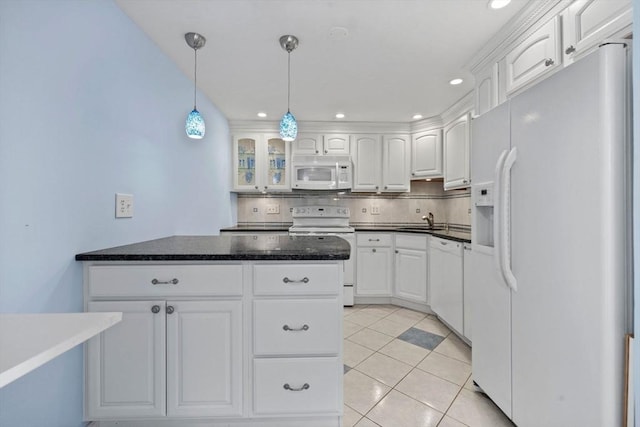 kitchen with white cabinets, tasteful backsplash, a sink, and white appliances