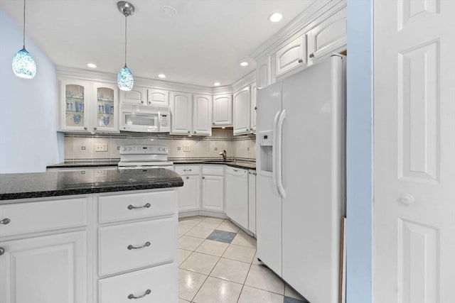 kitchen with white cabinets, decorative light fixtures, a sink, and white appliances