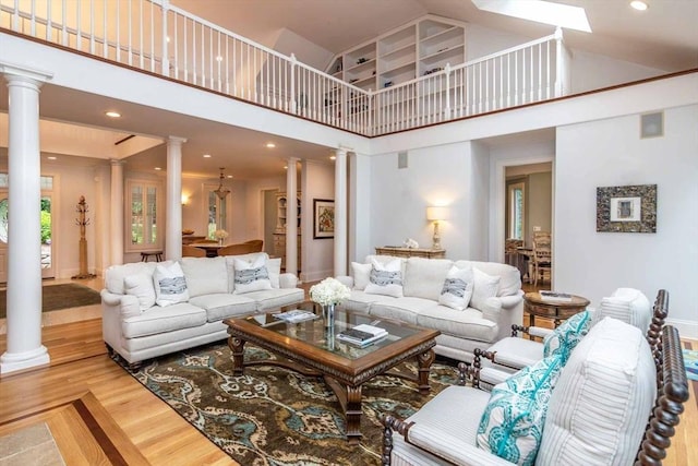 385 Barnes Rd, Oak Bluffs, MA 02557 - living room featuring ornate columns, high vaulted ceiling, wood finished floors, and recessed lighting
