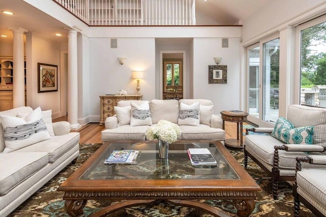 385 Barnes Rd, Oak Bluffs, MA 02557 - living room featuring ornate columns, wood finished floors, baseboards, recessed lighting, and vaulted ceiling
