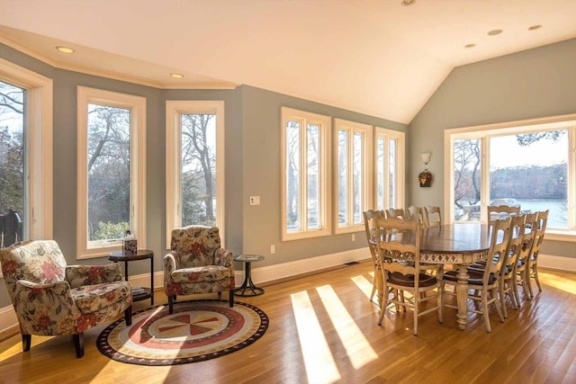 385 Barnes Rd, Oak Bluffs, MA 02557 - dining space with healthy amount of natural light, light wood-style flooring, baseboards, crown molding, and lofted ceiling