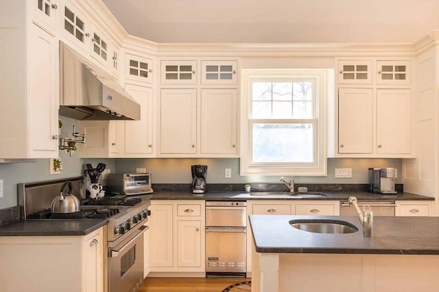 385 Barnes Rd, Oak Bluffs, MA 02557 - kitchen with high end stove, a sink, dark countertops, and under cabinet range hood