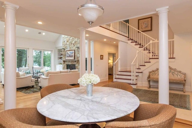 385 Barnes Rd, Oak Bluffs, MA 02557 - dining room with decorative columns, recessed lighting, wood finished floors, stairs, and vaulted ceiling