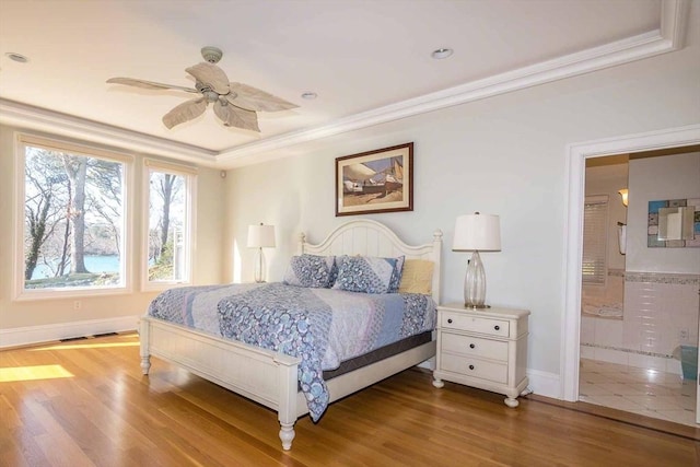 385 Barnes Rd, Oak Bluffs, MA 02557 - bedroom featuring wood finished floors, baseboards, ornamental molding, connected bathroom, and a tray ceiling