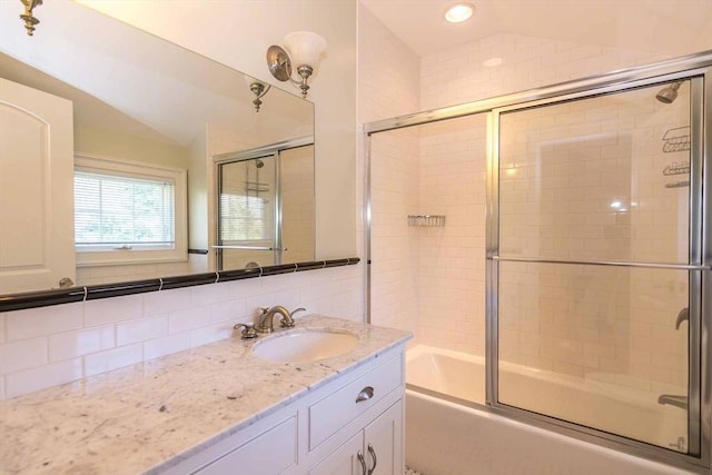 385 Barnes Rd, Oak Bluffs, MA 02557 - full bath with vaulted ceiling, bath / shower combo with glass door, tasteful backsplash, and vanity
