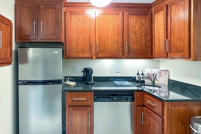 385 Barnes Rd, Oak Bluffs, MA 02557 - kitchen featuring stainless steel appliances, a sink, brown cabinetry, and dark stone countertops