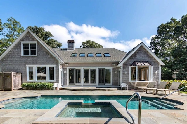 385 Barnes Rd, Oak Bluffs, MA 02557 - rear view of house with a chimney, a patio, a pool with connected hot tub, and a shingled roof