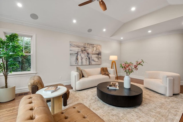 living area featuring lofted ceiling, visible vents, crown molding, and wood finished floors