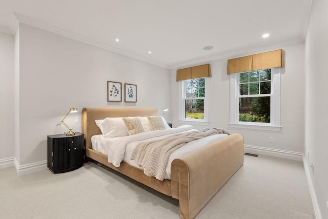 bedroom featuring light carpet, ornamental molding, visible vents, and baseboards