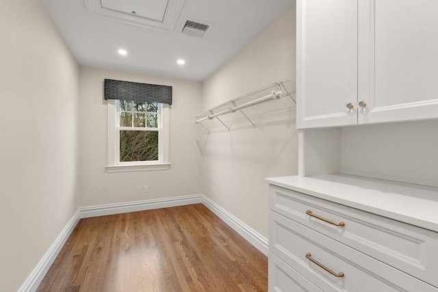 spacious closet featuring visible vents and light wood-style flooring