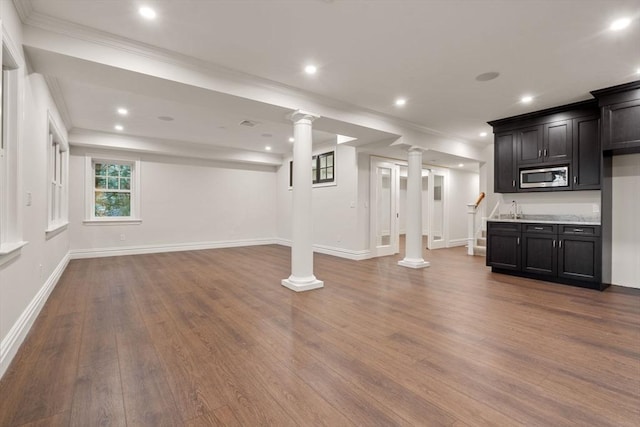 basement featuring ornamental molding, recessed lighting, baseboards, and wood finished floors