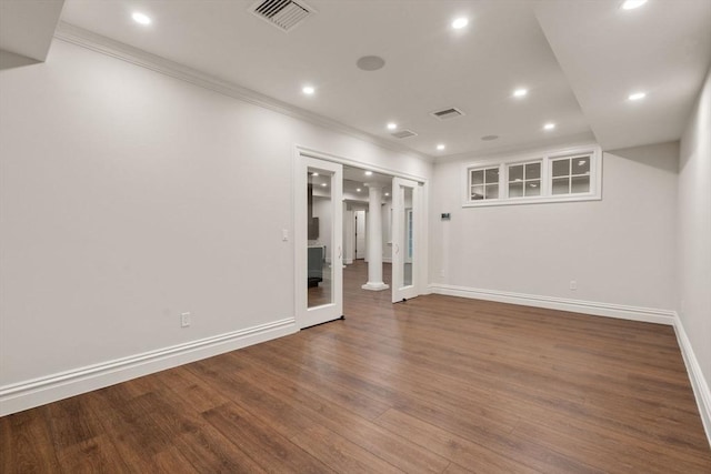 empty room featuring crown molding, recessed lighting, visible vents, wood finished floors, and baseboards