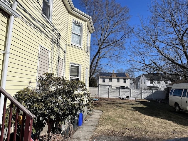 view of side of home with fence