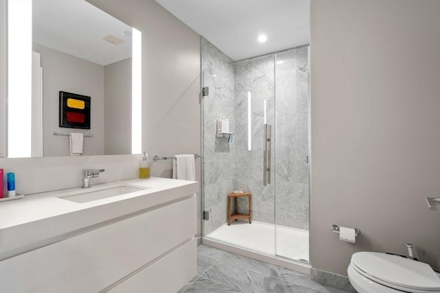 full bathroom featuring vanity, toilet, a stall shower, and marble finish floor