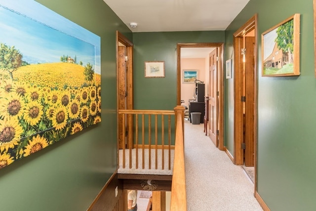 hallway featuring light colored carpet