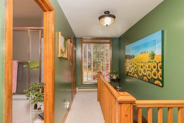 corridor featuring baseboard heating and light colored carpet