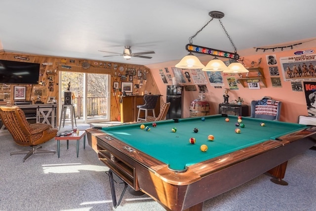 recreation room featuring wood walls, pool table, carpet flooring, and ceiling fan