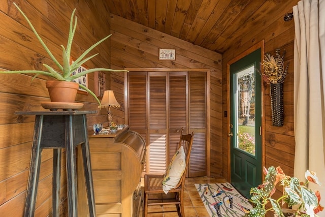 interior space featuring wooden ceiling and wooden walls