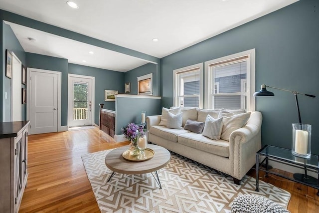 living room featuring baseboards, recessed lighting, and light wood-type flooring