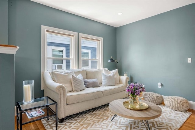 living room with baseboards and light wood-style floors