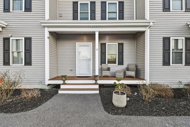 view of exterior entry with a porch