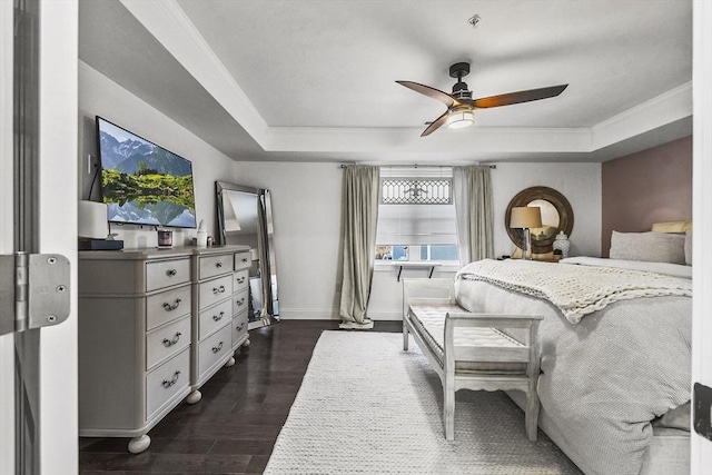 bedroom with ceiling fan, dark hardwood / wood-style flooring, and a raised ceiling